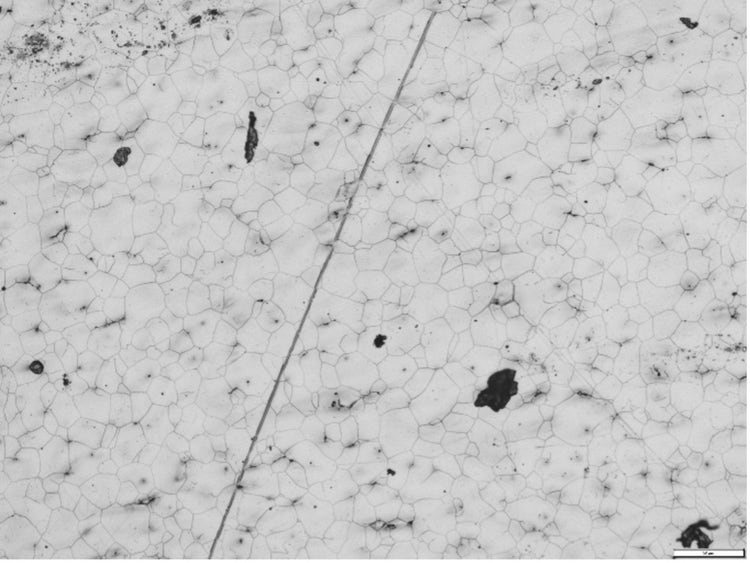 Metallographische Probe mit Korngrenzen, Polierspuren und Staub