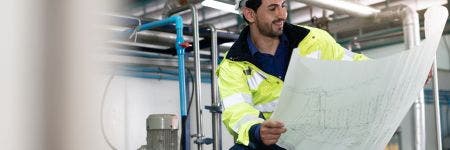 Weld inspector engineer planning his weld inspection using blueprints of the process piping in a pharmaceutical plant