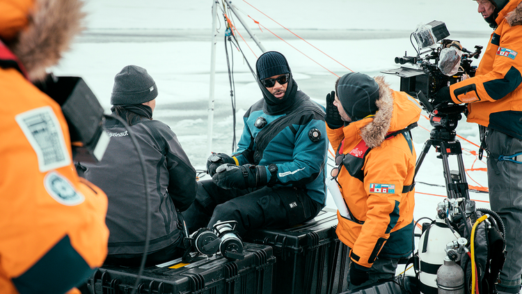 Will Smith prepares to dive under the ice with Dr. Allison Fong to collect samples in the waters of the North Pole.