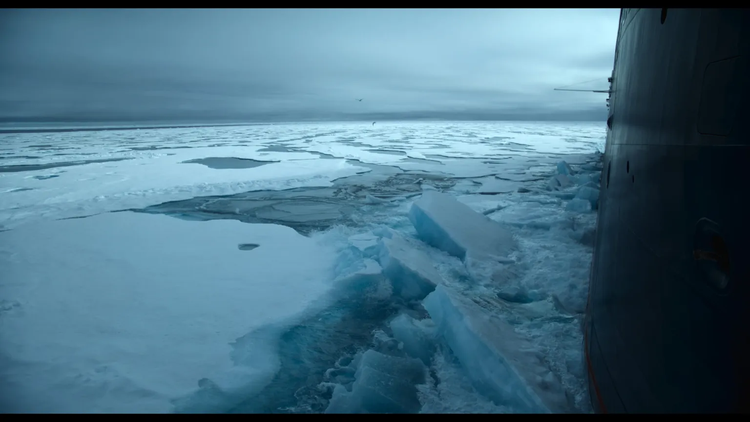 La Commandant Charcot cuts through the field ice in the Arctic.