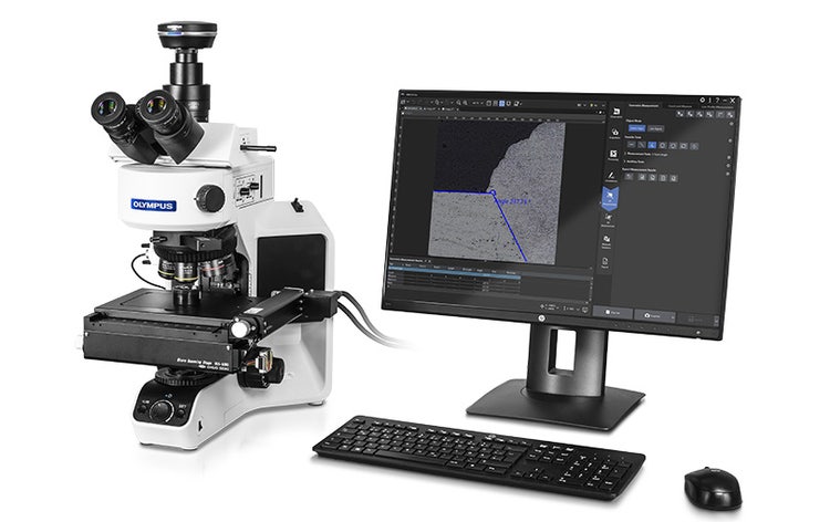 an upright microscope with a mounted microscope camera next to a computer screen showing PRECiV software's user interface.