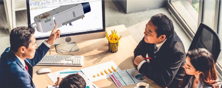 Mechanical engineers meeting with clients for a component design review using a 3D CAD drawing on a computer screen