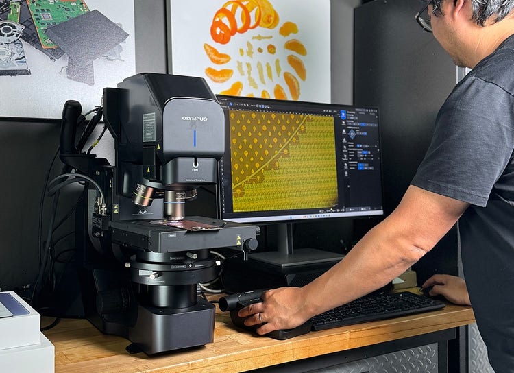 Arthur Shi working at the DSX2000 digital microscope in iFixit’s teardown lab