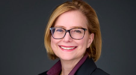 A person wearing glasses and smiling AI-generated content may be incorrect.