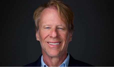 A person smiling at the camera AI-generated content may be incorrect.