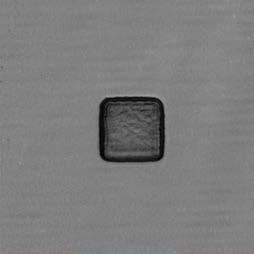 Figure 2. (a) A laser-scanning image shows the damaged cavity caused by the FIB. (b) An undamaged cavity. The OLS5000 microscope is nondestructive; cavities can be imaged at any point during the process flow of the device.